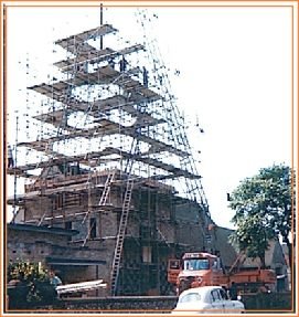 The spire under construction in 1966, encased in a tall pyramid of scaffolding.